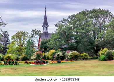 Wolfville, Nova Scotia, Canada - August 21, 2020 : Church And Garden  At Grand-Pré National Historic Site, Wolfville, Nova Scotia, Canada.

