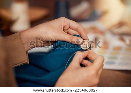 Womab, hands and sewing clothes button in studio for designer wear, fashion garment and creative fabric design. Tailor, boutique startup and fashion designer hand or seamstress working on clothing