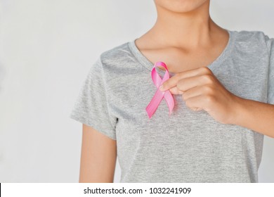 womaen hand holding pink ribbon breast cancer awareness. concept healthcare and medicine - Shutterstock ID 1032241909