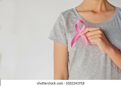 womaen hand holding pink ribbon breast cancer awareness. concept healthcare and medicine - Shutterstock ID 1032241918