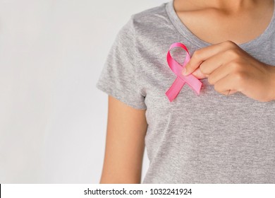 womaen hand holding pink ribbon breast cancer awareness. concept healthcare and medicine - Shutterstock ID 1032241924