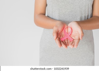 womaen hand holding pink ribbon breast cancer awareness. concept healthcare and medicine - Shutterstock ID 1032241939