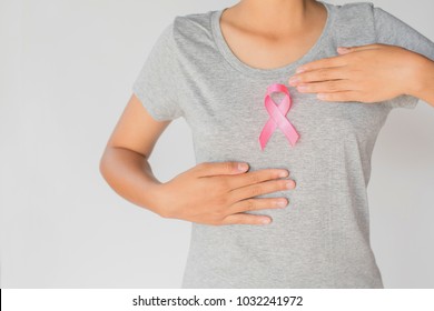 womaen holding pink ribbon breast cancer awareness. concept healthcare and medicine - Shutterstock ID 1032241972