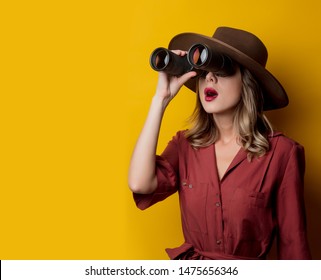 Woman in 1940s style clothes with binoculars