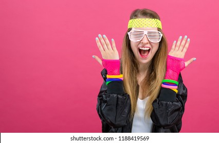 Woman In 1980's Fashion Theme On A Pink Background