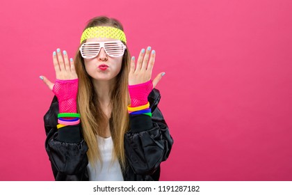 Woman In 1980's Fashion Theme On A Pink Background