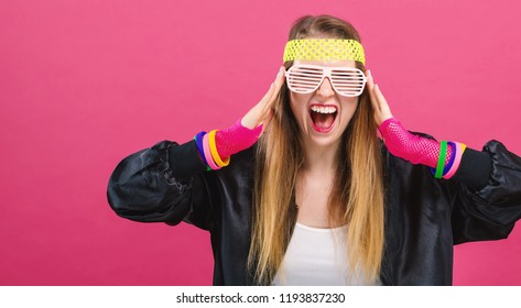 Woman In 1980's Fashion Theme On A Pink Background