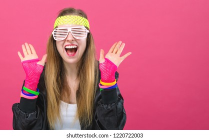 Woman In 1980's Fashion Theme On A Pink Background