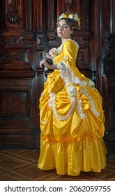 Woman In 19th Century Dress With Candles At The Royal Ball In The Castle