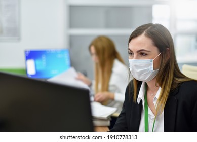 Woman 38 Years Old Office Manager In A Face Mask Works At A Computer In A Modern Office