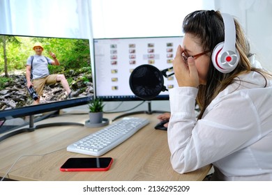 woman 40-45 years old, pretty female blogger sits in front of computer with green screen in front of microphone, emotionally talks on topic of business, communication during quarantine covid 19