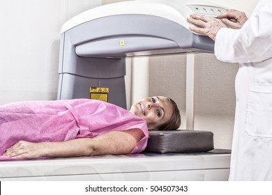 Woman In 40s Undergoing Open Mri With Doctor Supervising.