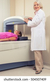 Woman In 40s Undergoing Open Mri With Doctor Supervising.