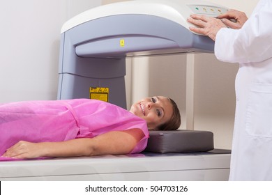 Woman In 40s Undergoing Open Mri With Doctor Supervising.