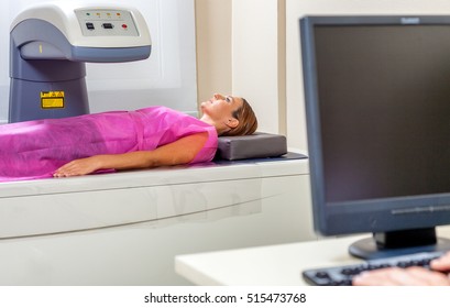 Woman In 40s Undergoing Open Mri With Doctor Supervising.