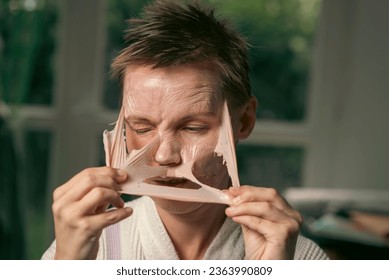 woman 43 years old with a cosmetic mask on her face - Shutterstock ID 2363990809