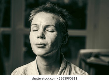 woman 43 years old with a cosmetic mask on her face - Shutterstock ID 2363990811