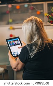 Woman 65-70 Years Old Using Ipad Tablet Pc Computer At Home