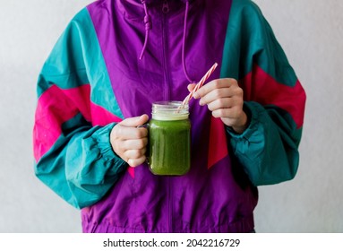 Woman In 90s Style Jacket Holding A Glass With Celery Juice