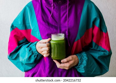 Woman In 90s Style Jacket Holding A Glass With Celery Juice