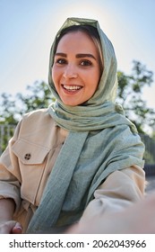 Woman In Abaya Recording Video At The Selfie Camera While Spending Time At The Street