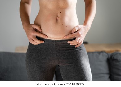 Woman abdomen with cesarean scar. Home candid lifestyle. C section surgery for pregnant woman. Recovering after birth.  - Shutterstock ID 2061870329