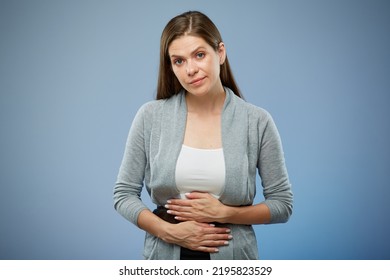 Woman With Abdominal Pain With Hands On Her Stomach. Isolated Female Portrait On Blue.