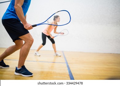 Woman about to serve the ball in the squash court - Shutterstock ID 334429478