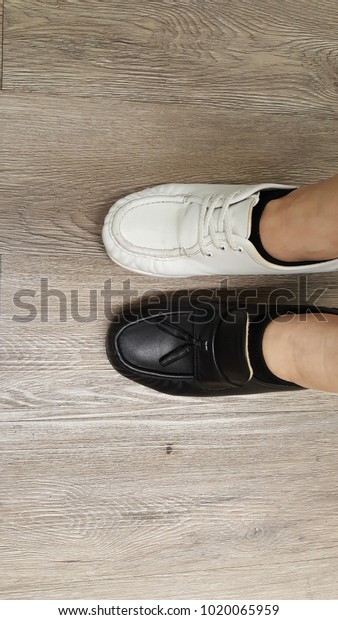 one black one white shoes