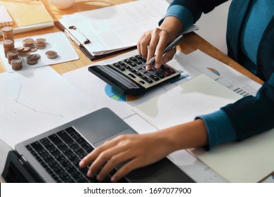 Woman Accountant Use Calculator And Computer On Desk In Office. Work For Safe At Home. Finance And Accounting Concept