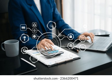 Woman accountant use Laptop and calculator to calculate the company's financial with icon banking on data network of finance and banking with business growth in office - Shutterstock ID 2366200471