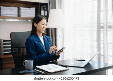 Woman accountant use Laptop and calculator to calculate the company's financial with icon banking on data network of finance and banking with business growth  - Shutterstock ID 2366200473