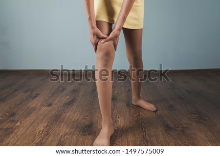 woman ache feet on dark background
