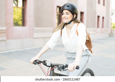 Woman with an active and fitness lifestyle choosing to use a green and eco-friendly bike in her commute to work 