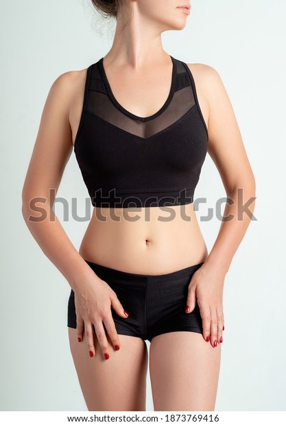 Woman\
activewear. Clothing template. Sport fashion. Fitness style outfit.\
Female athlete model with slim body in logo mockup black mesh crop\
top shorts isolated on neutral\
background.