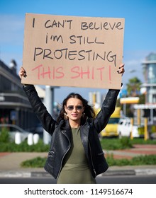 Woman Activist Protester Holding Up Protest Sign, Unhappy Dissatisfied About Social Issues