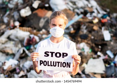 Woman Activist With Stop Polution On Waste Dump. Recycle, Eco, Reuse Concept.