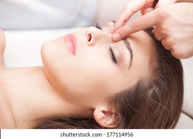 Woman Acupressure Face Massage Closeup