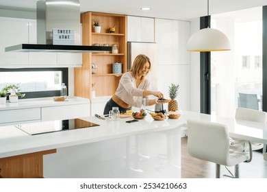 Woman Adding Blueberries to Blender for Healthy Smoothie - Powered by Shutterstock