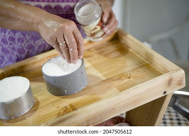 Woman Adding Salt To Artisan Soft Goat Cheese