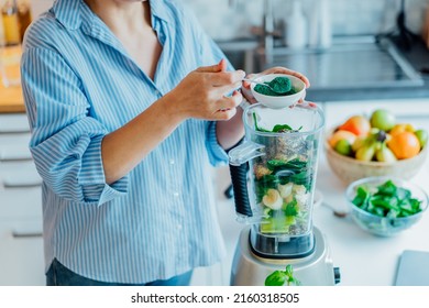 Woman Adding Spirulina Green Powder During Making Green Smoothie On The Kitchen. Superfood Supplement. Healthy Detox Vegan Diet. Healthy Dieting Eating, Weight Loss Program. Selective Focus.