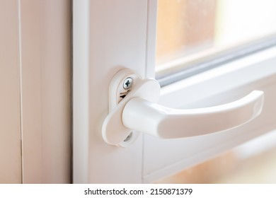 Woman Adjusting White Pvc Plastic Balcony Window Door Indoors. Female Using Screwdriver To Repair Upvc Window Lock. House Doors And Windows Maintenance Concept. Draft Fixing Conceptual.