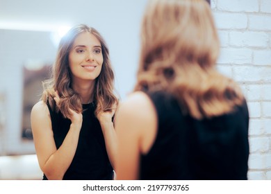 
Woman Admiring Her New Look in the Mirror at a Hair Salon. Happy client loving her new colored coiffure 
