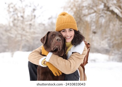 Woman with adorable Labrador Retriever dog in snowy park - Powered by Shutterstock - Get 15% off with code: PIKWIZARD15