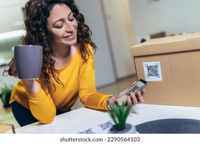 Woman affixing QR codes onto storage boxes. Concept organization, efficiency, or technology in storage management.