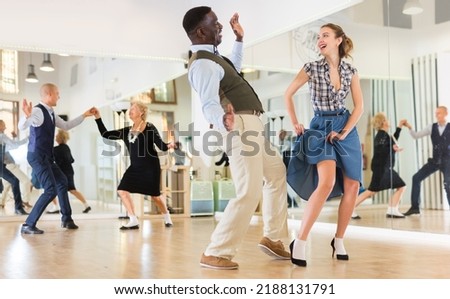 Woman with african man practising charleston dancing