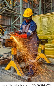 Woman African Worker With Red Gloves  Cutting With A Torch Corner Metal In A Steel Factory In Botswana Africa