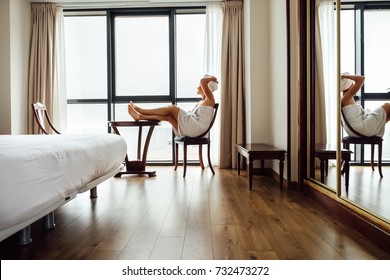 Woman After Shower Relax In Hotel Room Near The Panorama Window