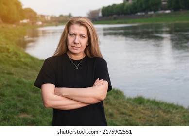 A Woman Against The Background Of Nature, The River Stands With A Stern, Slightly Angry Look, She Needs To Go Home To Cook, Clean The House, But She Doesn't Want To, She Wants Peace And Rest