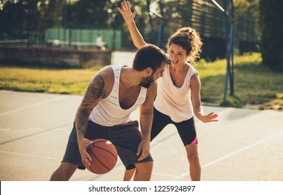  Woman Against A Man. Couple Playing Basketball.